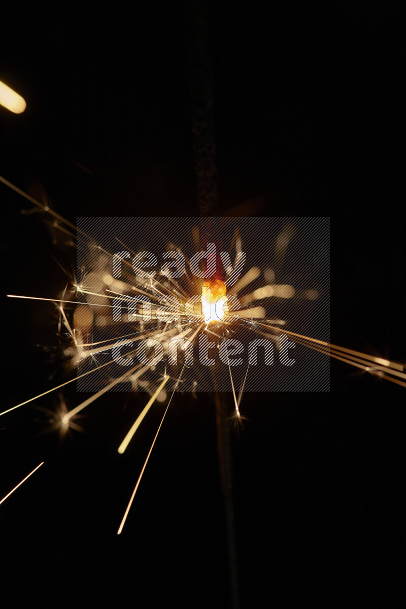 A close-up image of sparkler candle isolated on black background