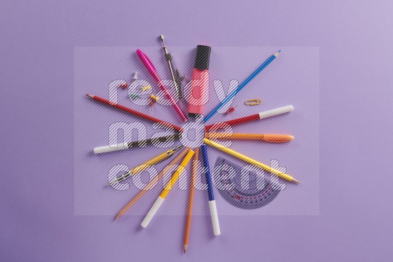 Different school supplies on purple background