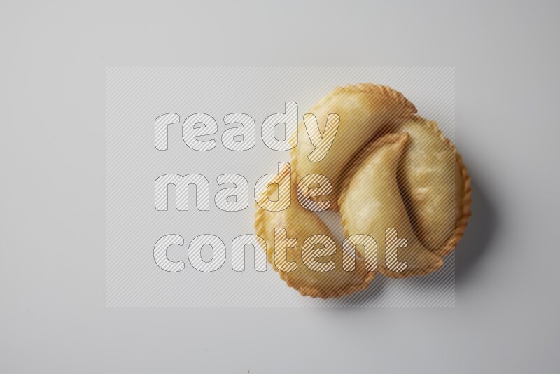 Four fried sambosa from a top angle on a white background