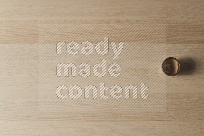 A pottery cup on light wooden background