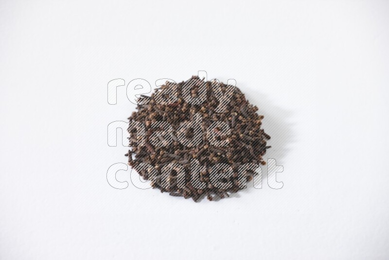 Cloves in a circle shape on a white flooring