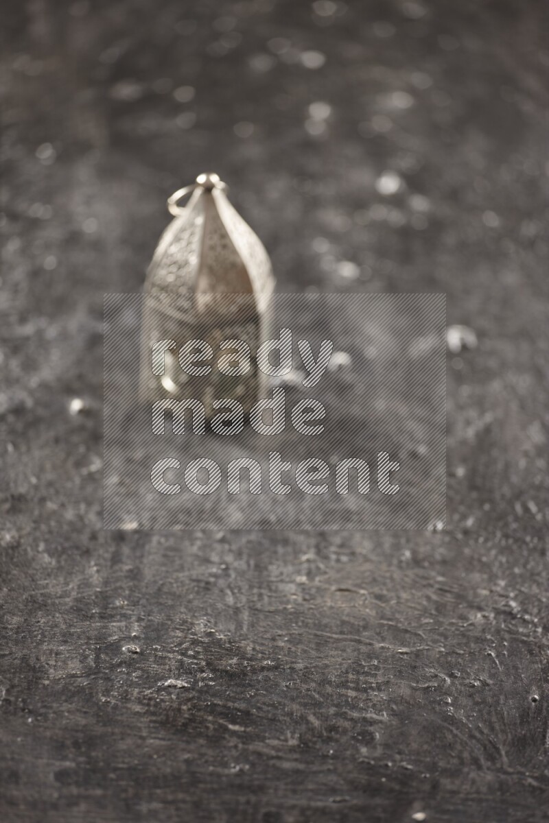 An out of focus lantern on textured black background