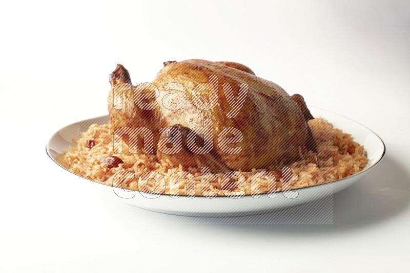 red basmati Rice with whole roasted chicken on a white plate with a silver rim direct on white background