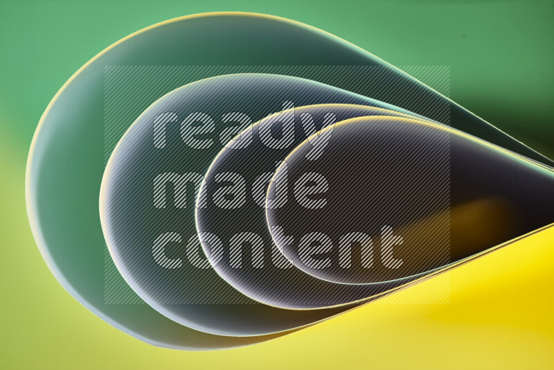 An abstract art of paper folded into smooth curves in green and yellow gradients