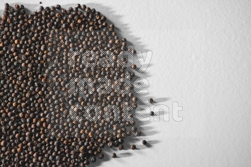 Black pepper on a white flooring