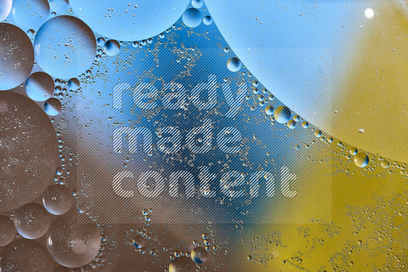 Close-ups of abstract oil bubbles on water surface in shades of yellow, brown and blue