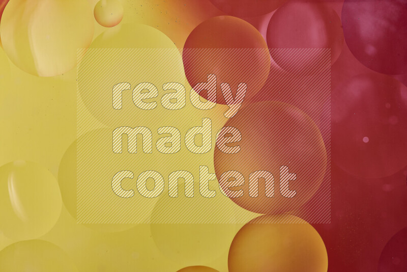 Close-ups of abstract oil bubbles on water surface in shades of red and yellow