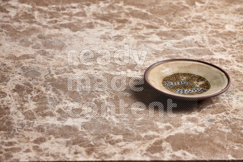 Decorative Pottery Plate on Beige Marble Flooring