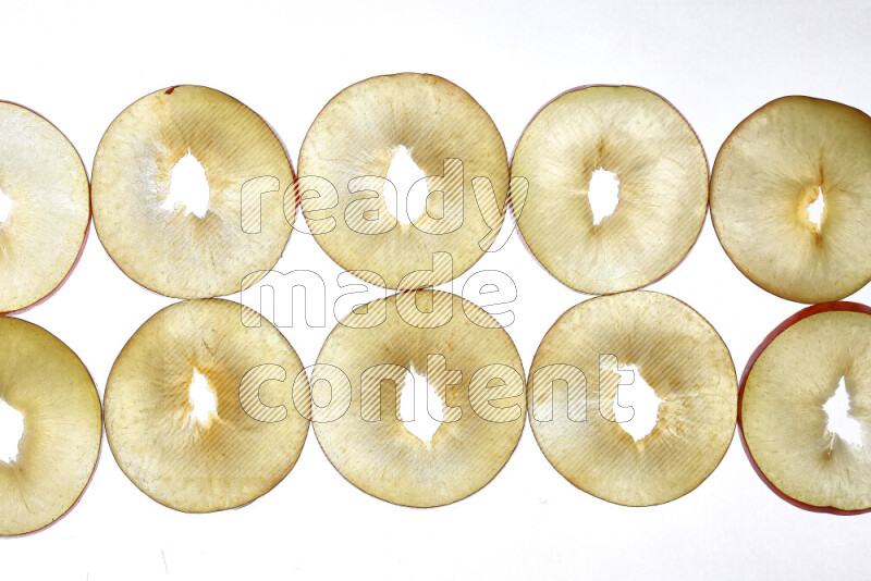 Peach slices on illuminated white background