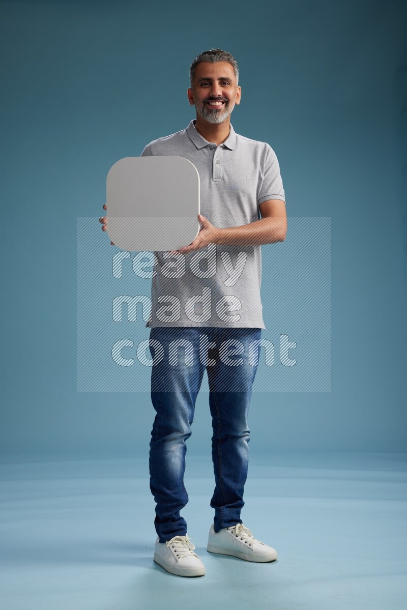 Man Standing holding social media sign on blue background