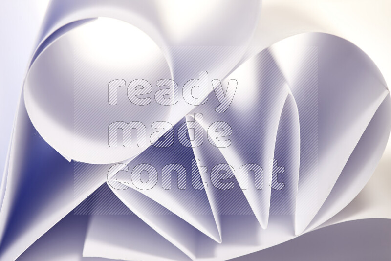 An artistic display of paper folds creating a harmonious blend of geometric shapes, highlighted by soft lighting in grey