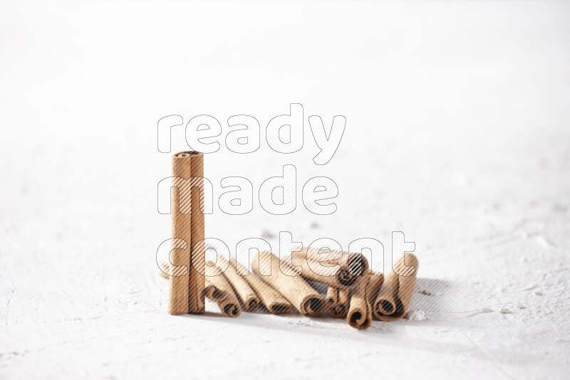 Cinnamon sticks on a textured white background