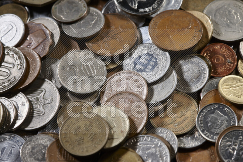 A close-ups of random old coins on black background
