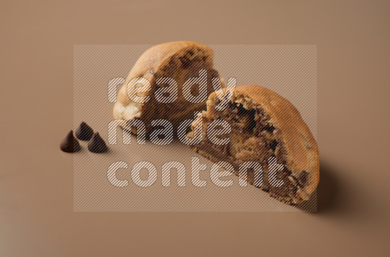 a cookie cut in half on a brown background
