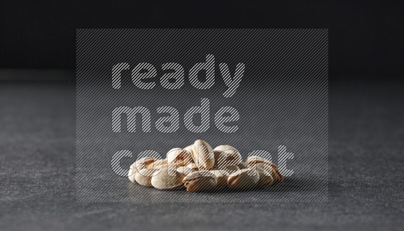 A bunch of pistachios on a black background in different angles