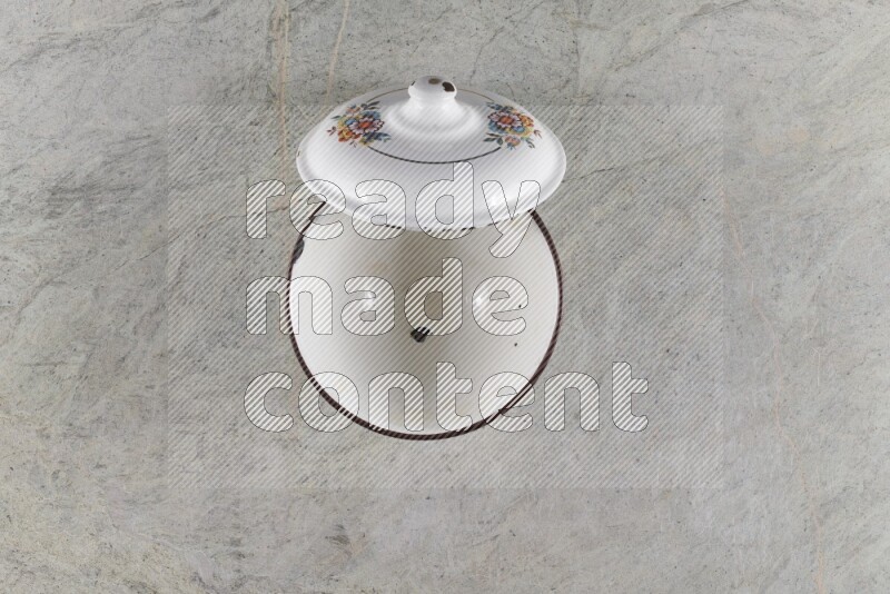 A vintage metal pot on grey marble background