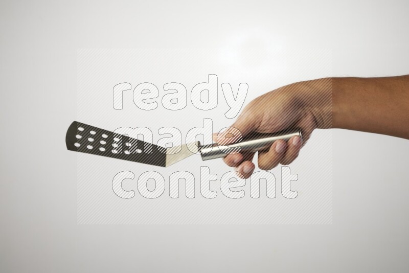 Male Hand Holding Burger Flipper on white background