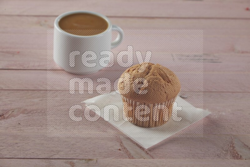 Vanilla cupcake on a wooden pink background