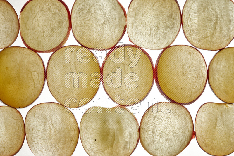 Plum slices on illuminated white background