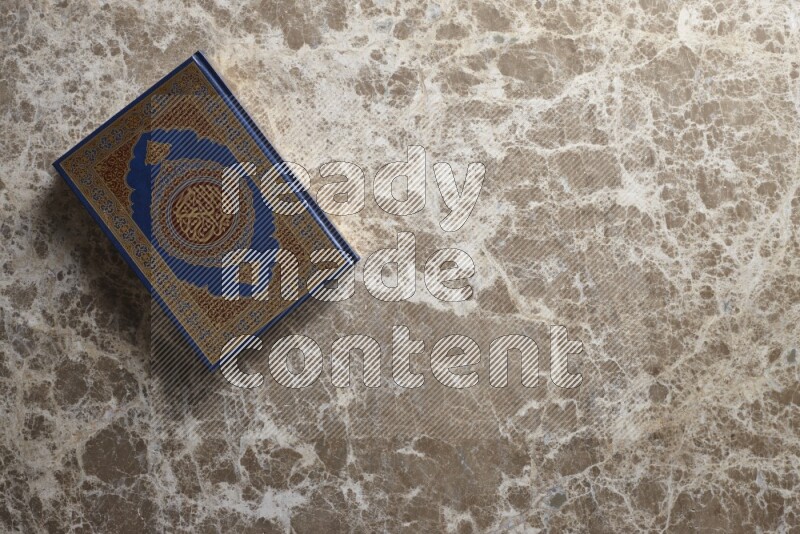The holy Quran on beige marble background