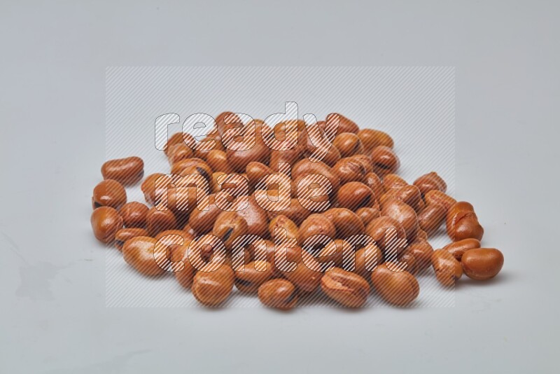 Close up shot of cooked fava beans (foul) on white background