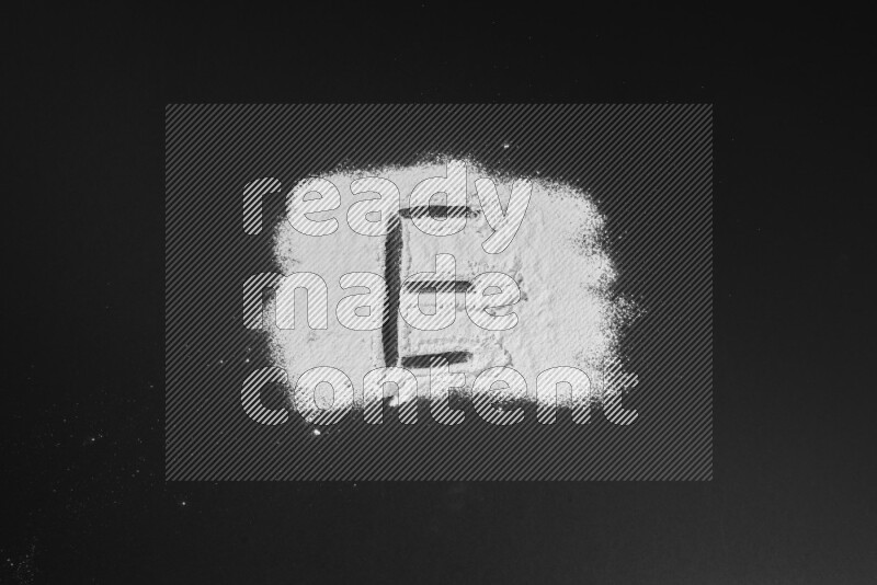 Alphabets written with powder on black background