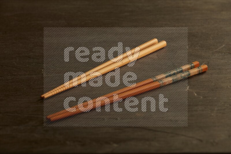 wooden chopsticks on black slate background