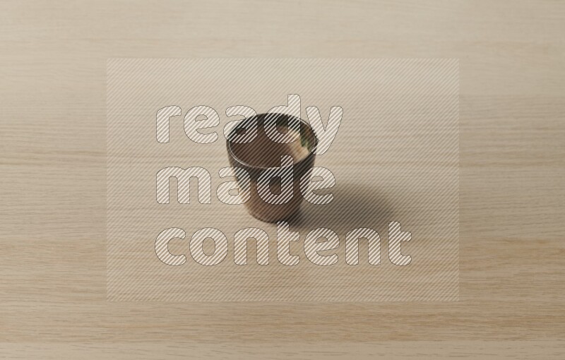 A pottery cup on light wooden background