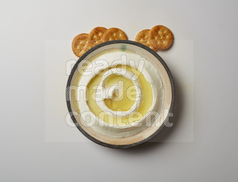 Lebnah garnished with olive oil in a pottery plate on a white background