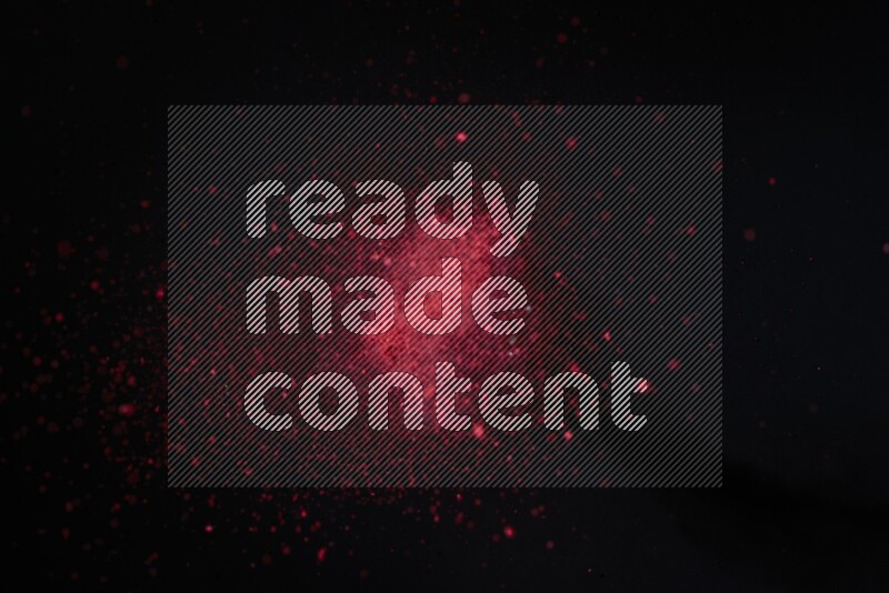 Red powder explosion on black background