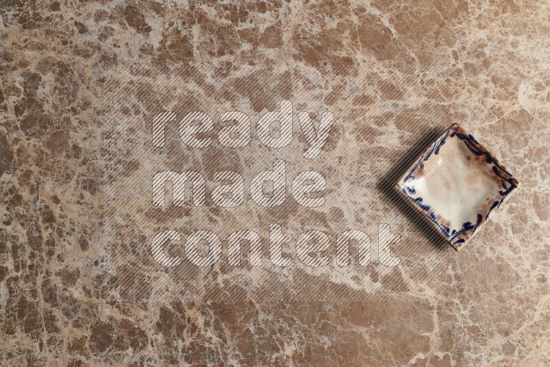 A decorative pottery plate on beige marble background