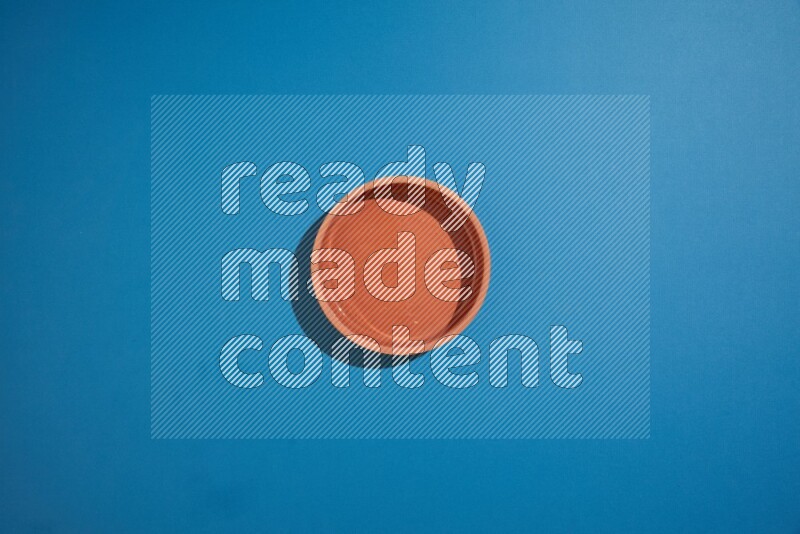 brown bowl on blue background