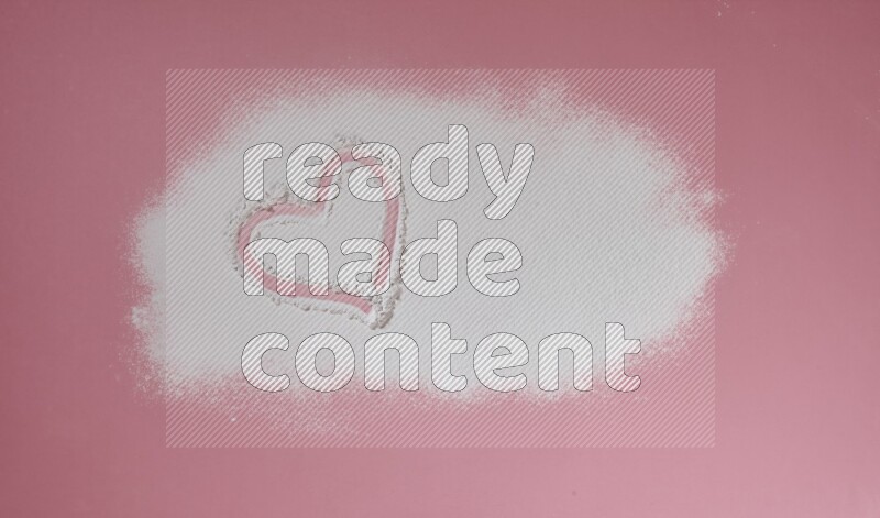 A heart drawn with white powder on pink background