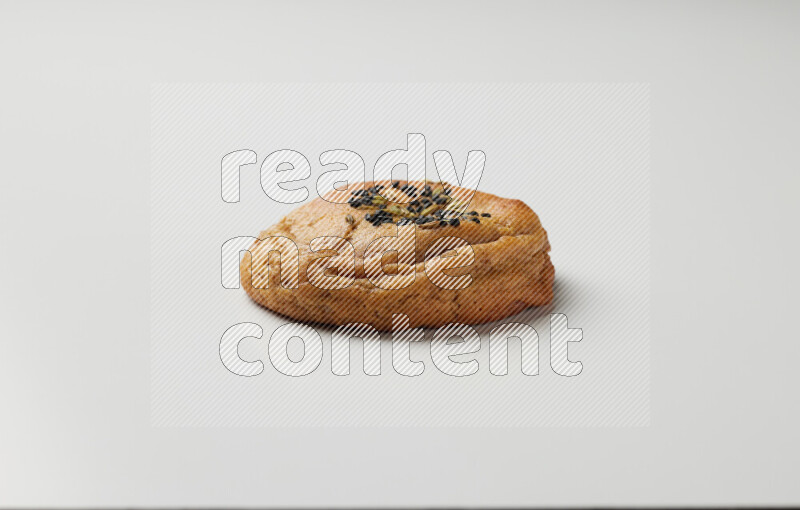 Hasawi cookie field with date and decorated by black seed and Anise grain on a white background