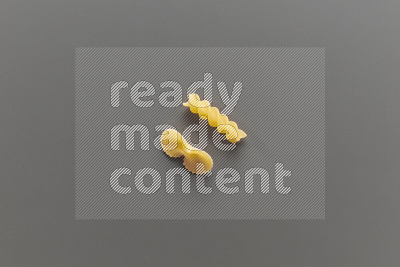 Fiocchi pasta with other types of pasta on grey background
