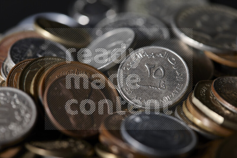 A close-ups of random old coins on black background