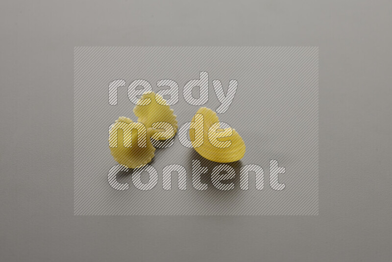 Fiocchi pasta with other types of pasta on grey background