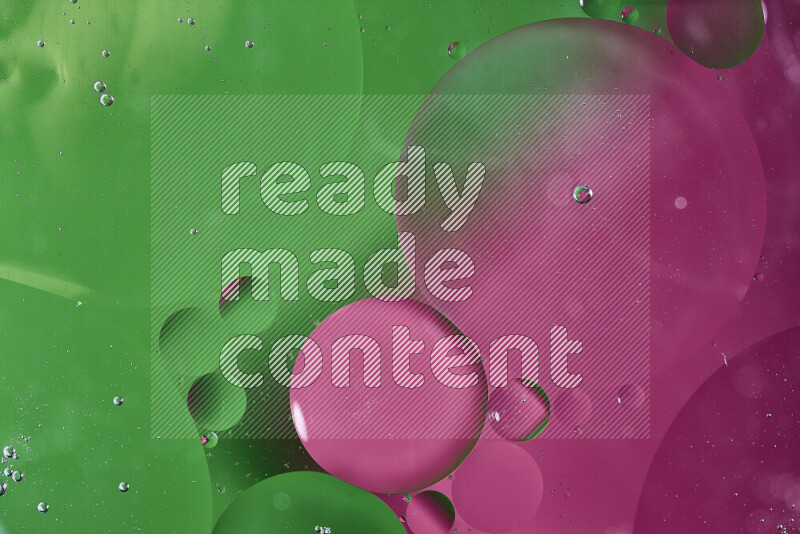 Close-ups of abstract oil bubbles on water surface in shades of green and pink