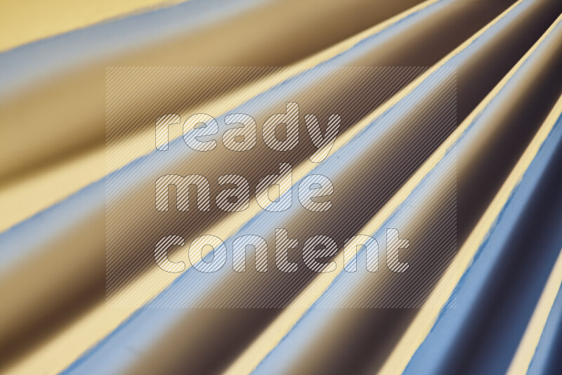 An image presenting an abstract paper pattern of lines in blue and gold tones