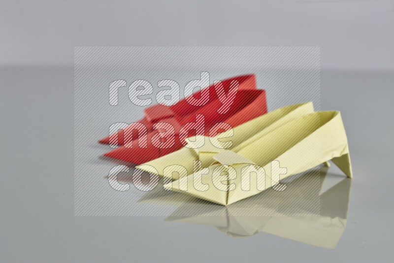 Origami shoes on grey background