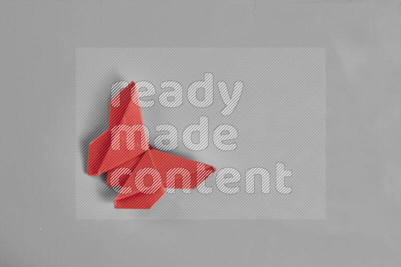 Origami butterfly on grey background