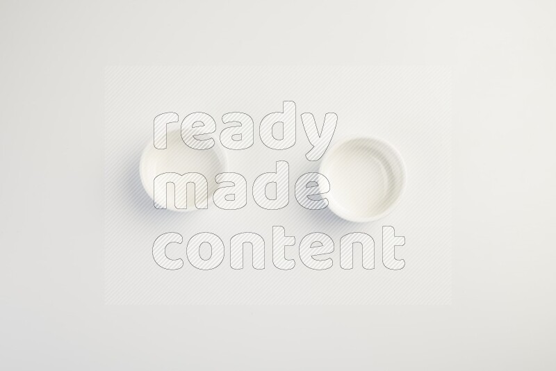 white ceramic round sauce dish on white countertop