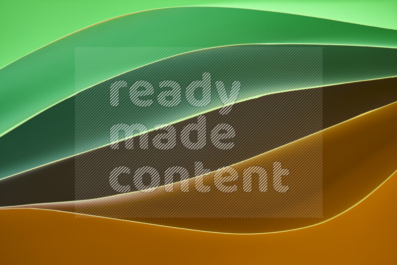 This image showcases an abstract paper art composition with paper curves in green and orange gradients created by colored light