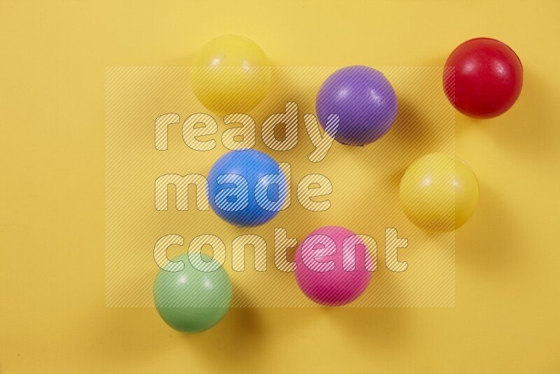 Multicolored plastic balls on different colored backgrounds (kids toys)
