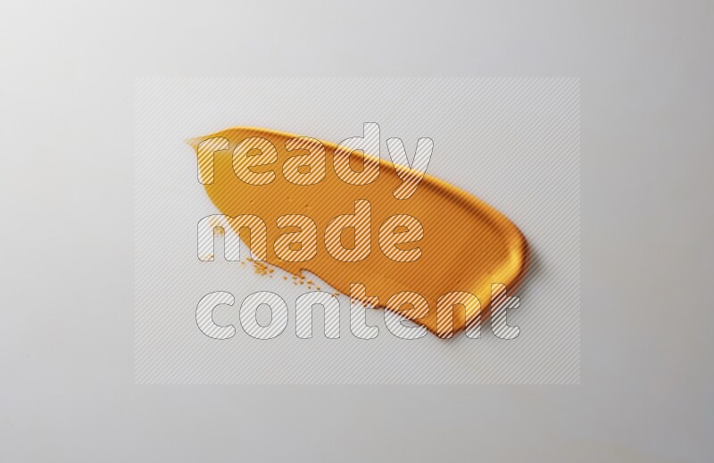 An orange straight painting knife stroke on white background