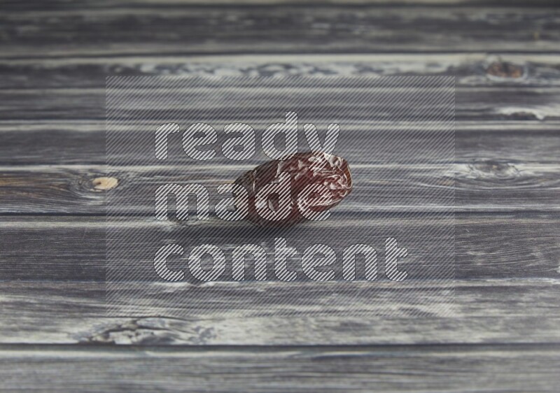 one madjoul date on a wooden grey background