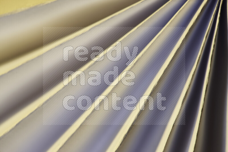 An image presenting an abstract paper pattern of lines in white and gold tones