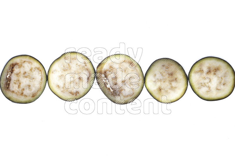 Eggplant slices on illuminated white background