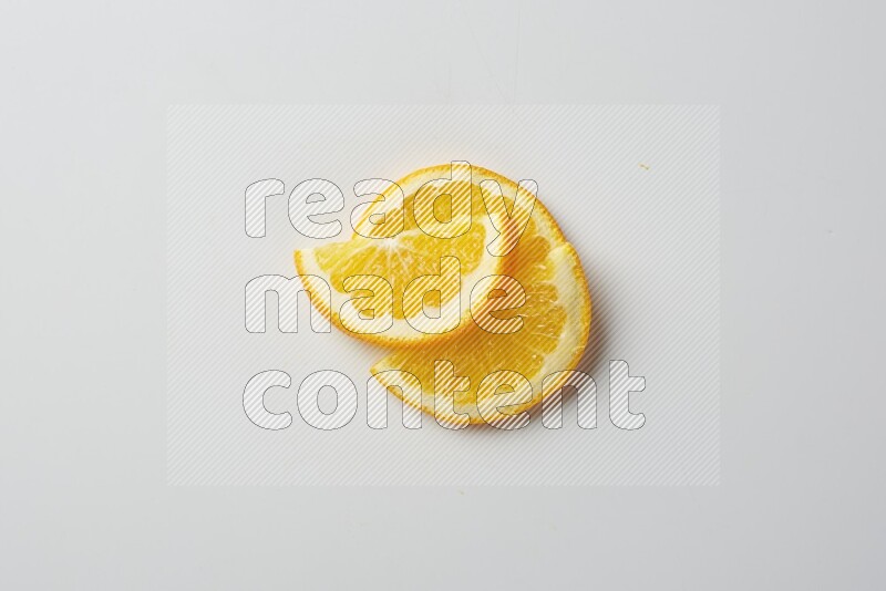 Three halves of an orange slices on white background