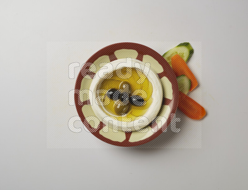 Lebnah garnished with olives in a traditional plate on a white background